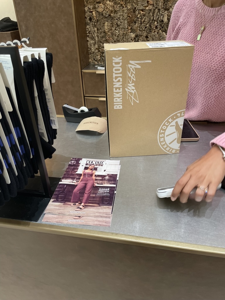 Birkenstock x Stussy collaboration box on a store counter.