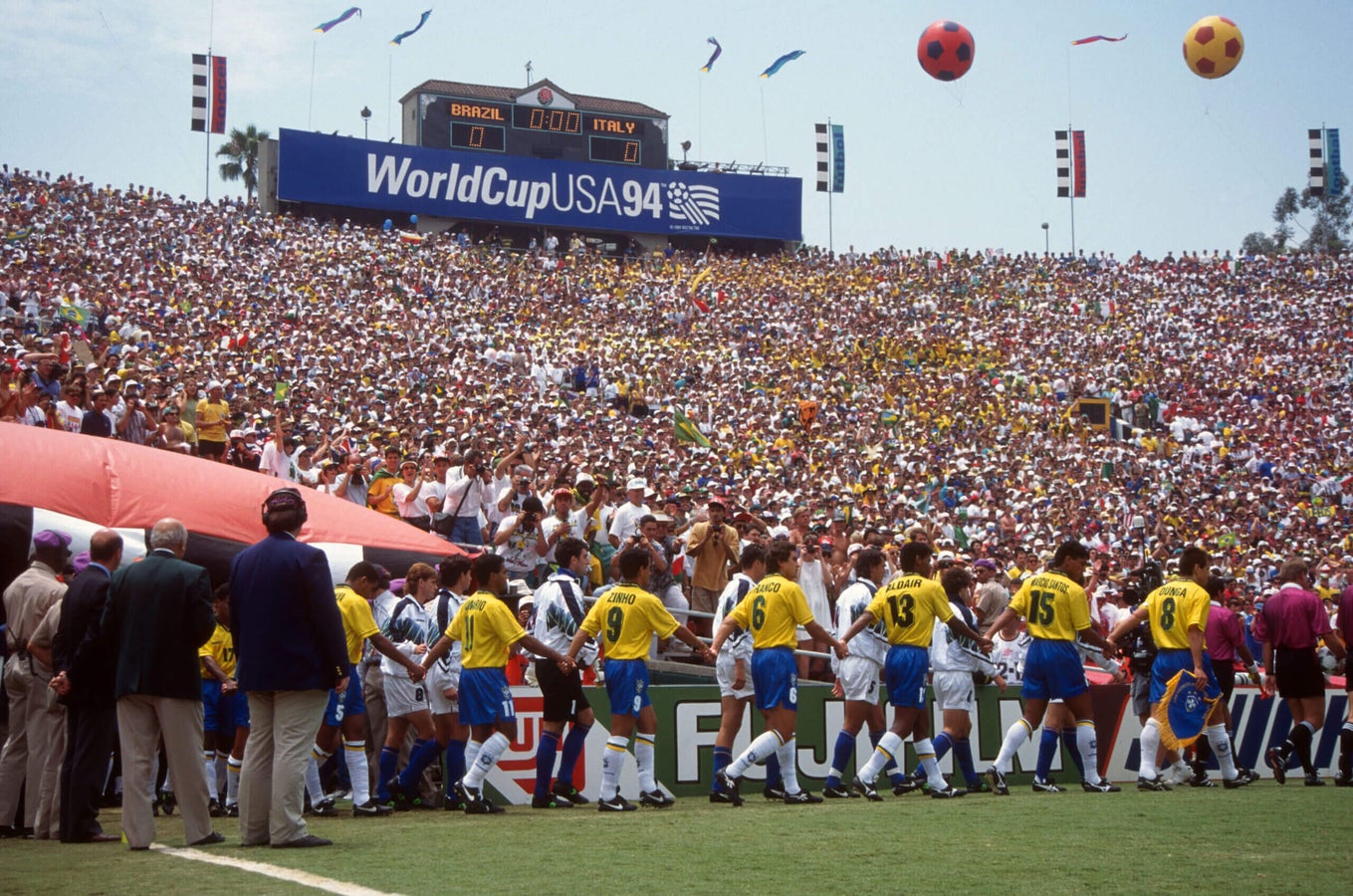 Brazil and Italy players walking out onto the field together before the 1994 World Cup final, holding hands.